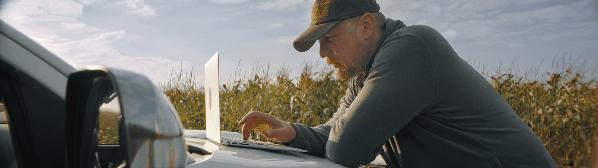 Male farmer calculating finance options using National Ag farm loan calculator