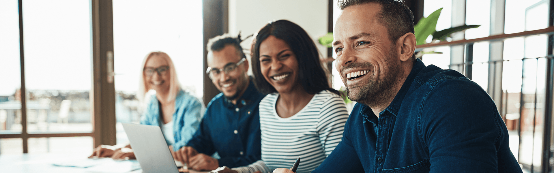 Smiling team members of farm lending sitting together in a meeting